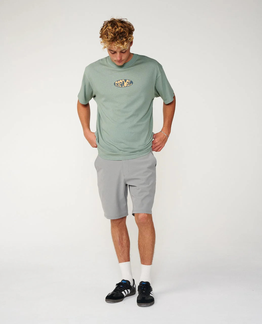Rip Curl Boardwalk Phase 19 Short Person wearing a green t-shirt and gray shorts on a white background
