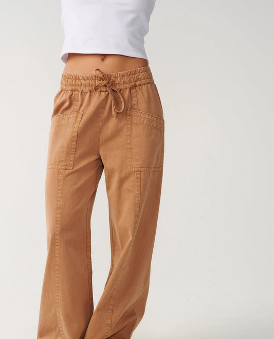 Rip Curl Bossa Nova Twill Wide Leg Pant a woman wearing brown twill pants and a white shirt with an elastic waist and a tie