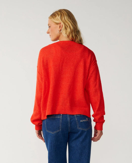 Rip Curl Emily Cardigan a woman wearing a red cardigan, the view of her back