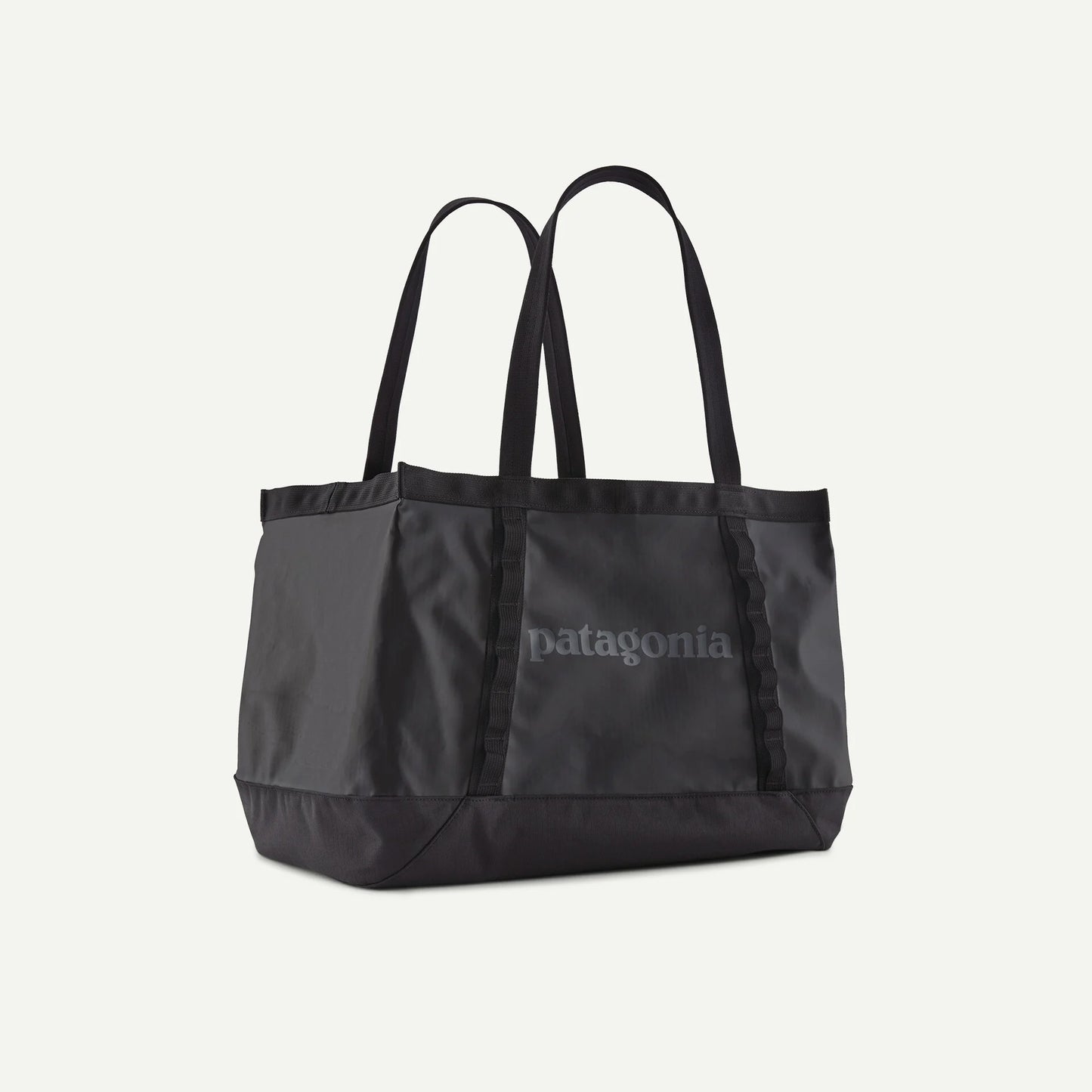 Black tote bag with Patagonia logo on a light gray background