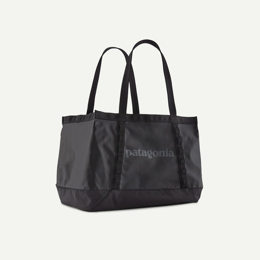 Black tote bag with Patagonia logo on a light gray background