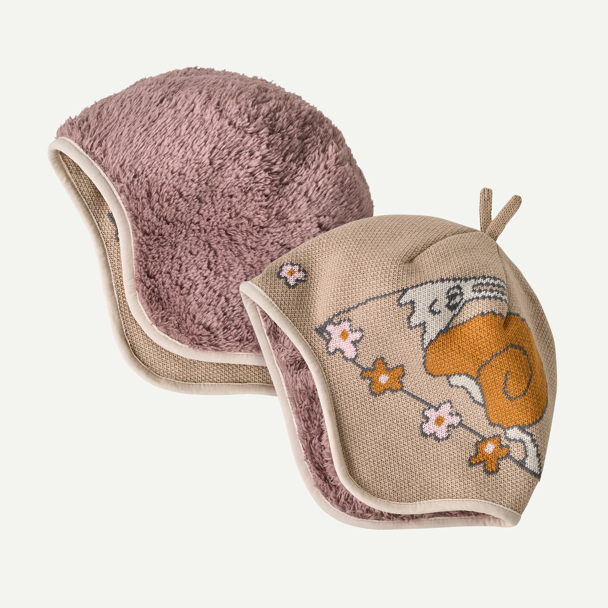 A reversible youth beanie with mauve on one ide and tan design o the other