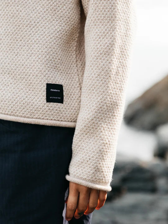 Close up of women's sleeve oatmeal coloured wool sweater