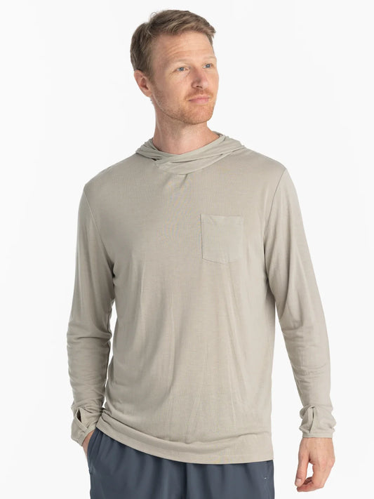 Man standing wearing a tan colour UPF shirt with hood