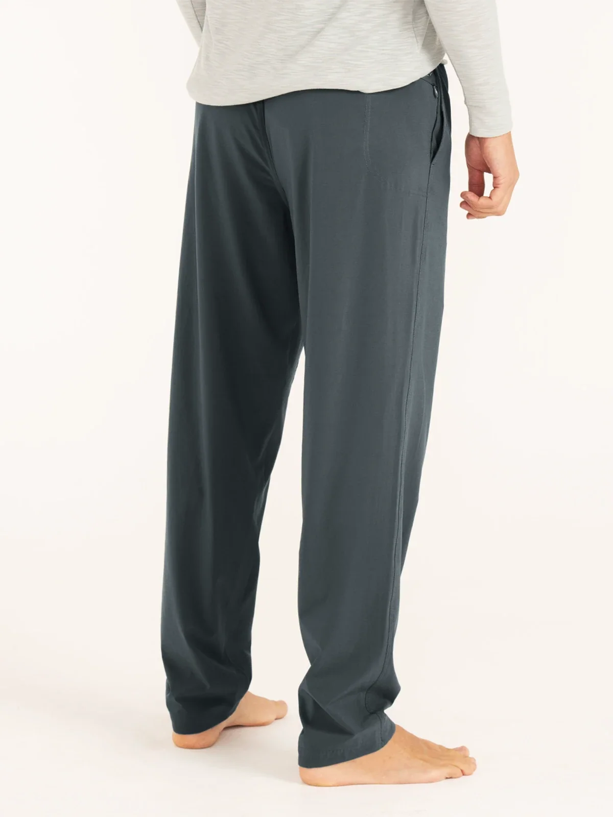 The side and back view of a man wearing a pair of upf pants 