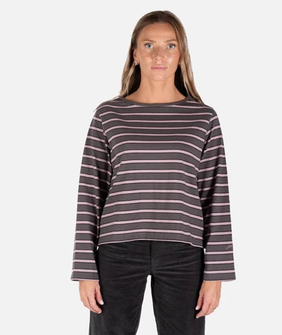 Woman standing in studio in striped charcoal shirt