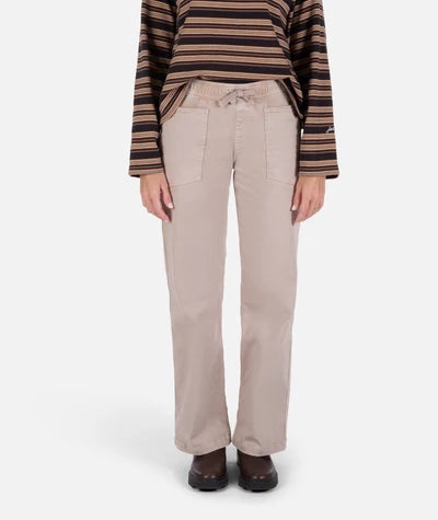 Person wearing beige pants and a striped sweater on a white background