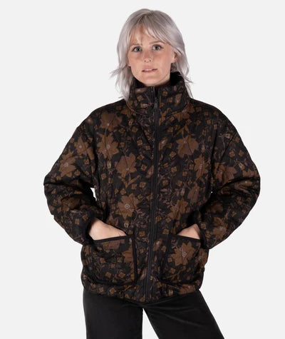 Jetty Rainier Reversible Puffer Jacket women with hands in pockets of designer jacket