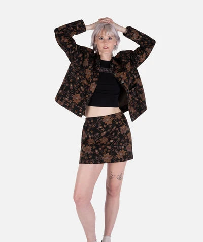 Jetty Supply Piper Jacket Person wearing a brown floral jacket and skirt set on a white background