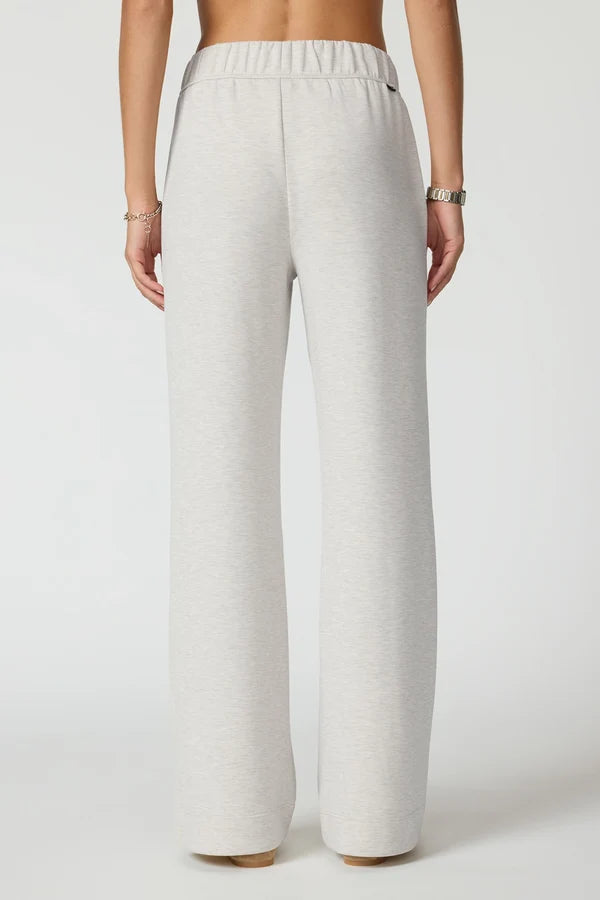 MPG  Dreamweave Relaxed Pants back view of woman wearing moonbeam coloured pants with no pockets.