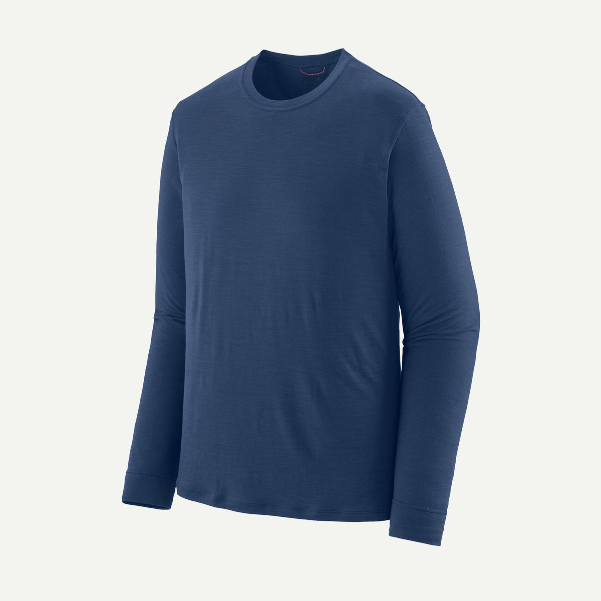 a blue long sleeve merino blend shirt on a white background