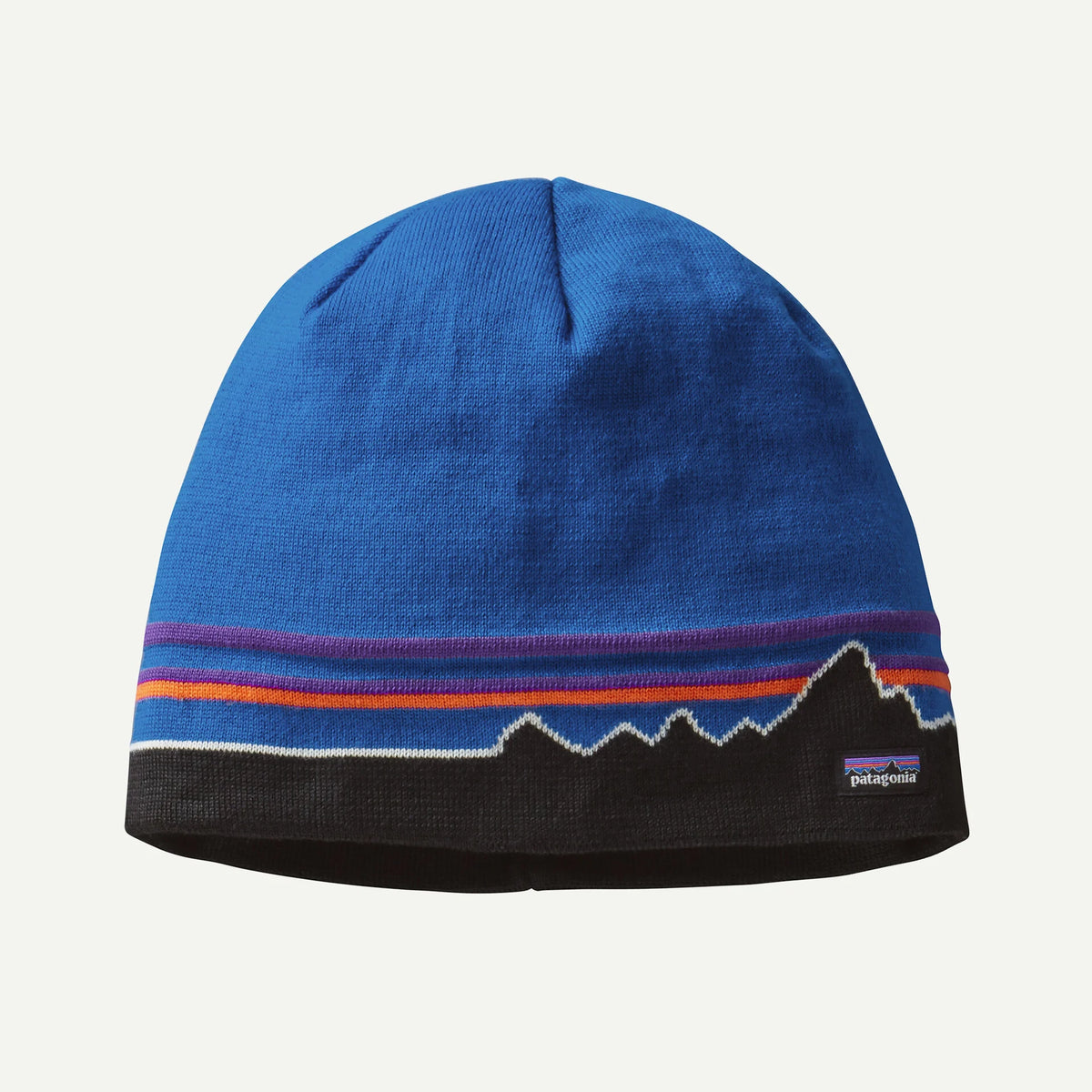 a blue and black beanie with a mountain range log design on a white background