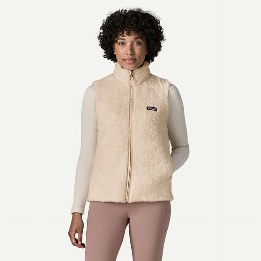 Patagonia Los Gatos Vest a woman stands with her hand in the side pocket of soft fluffy full zip vest.