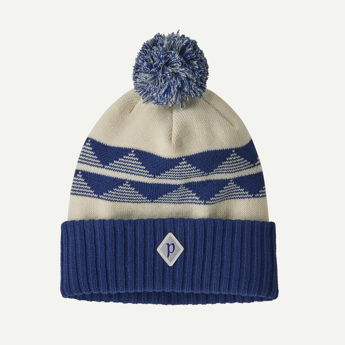 a blue and white pattern beanie with pompom on a white background.