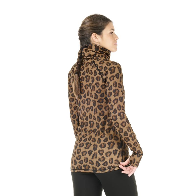 Back view of a woman in a white studio space wearing an animal print base layer and black tights.