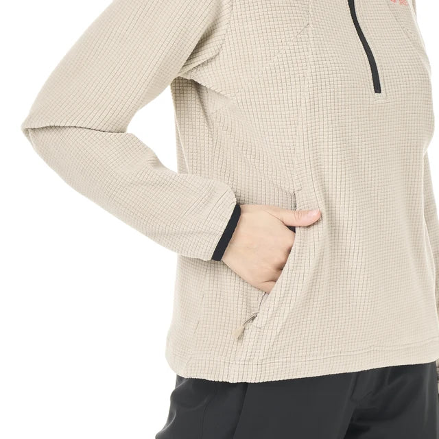 A person has their hand in the front kangaroo pocket of their grid fleece