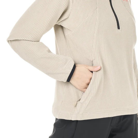 A person has their hand in the front kangaroo pocket of their grid fleece