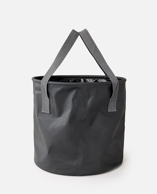 Rip Curl 50L Bucket A dark gray collapsible fabric storage bucket with dual shoulder straps, shown on a clean white background.