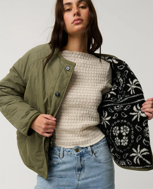 Rip Curl Bossa Nova Revo Jacket woman wearing green with fleece designed interior.