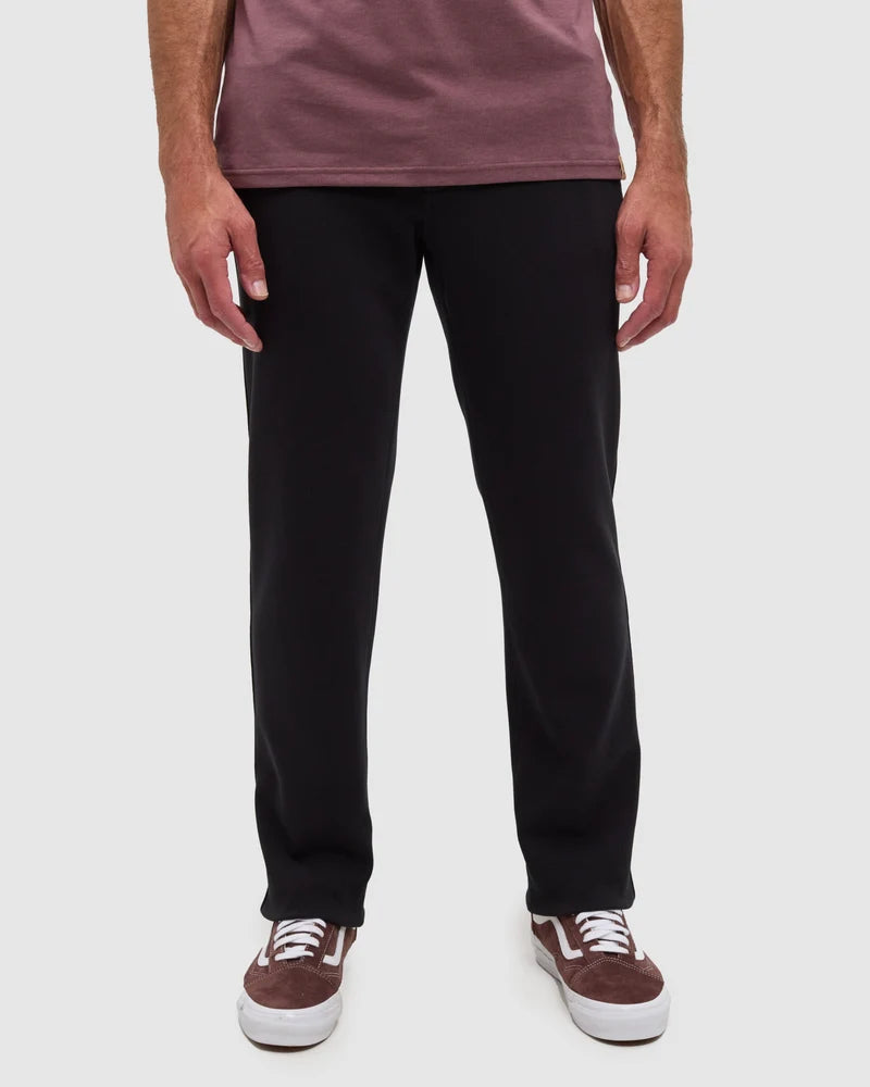 A person wearing black Clark pats form Tentree 