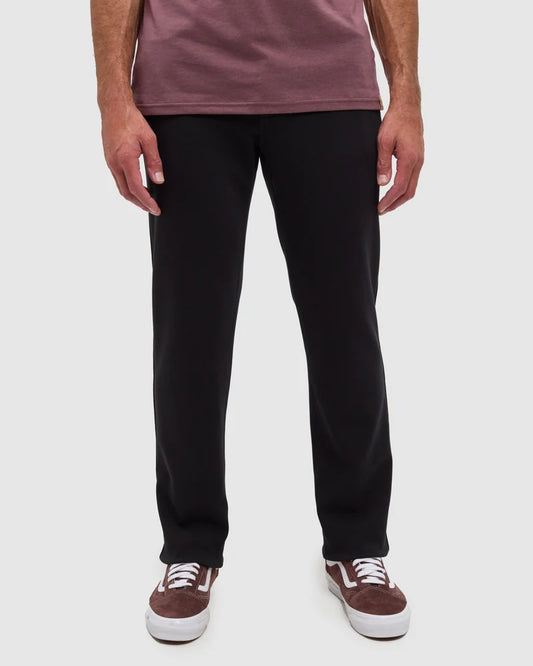 A person wearing black Clark pats form Tentree 