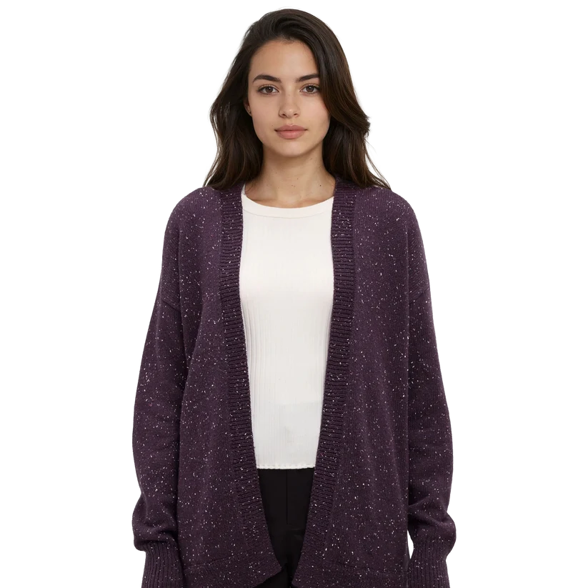 A woman wears a purple long cardigan from tentree with a  white t shirt and dark pants