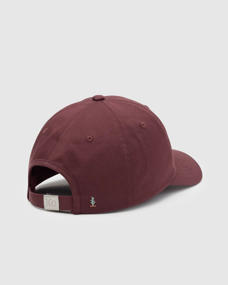 Tentree Sasquatch Peak Hat A maroon baseball cap shown from a rear three-quarter angle on a light gray background, featuring an adjustable strap and a small embroidered logo on the side.