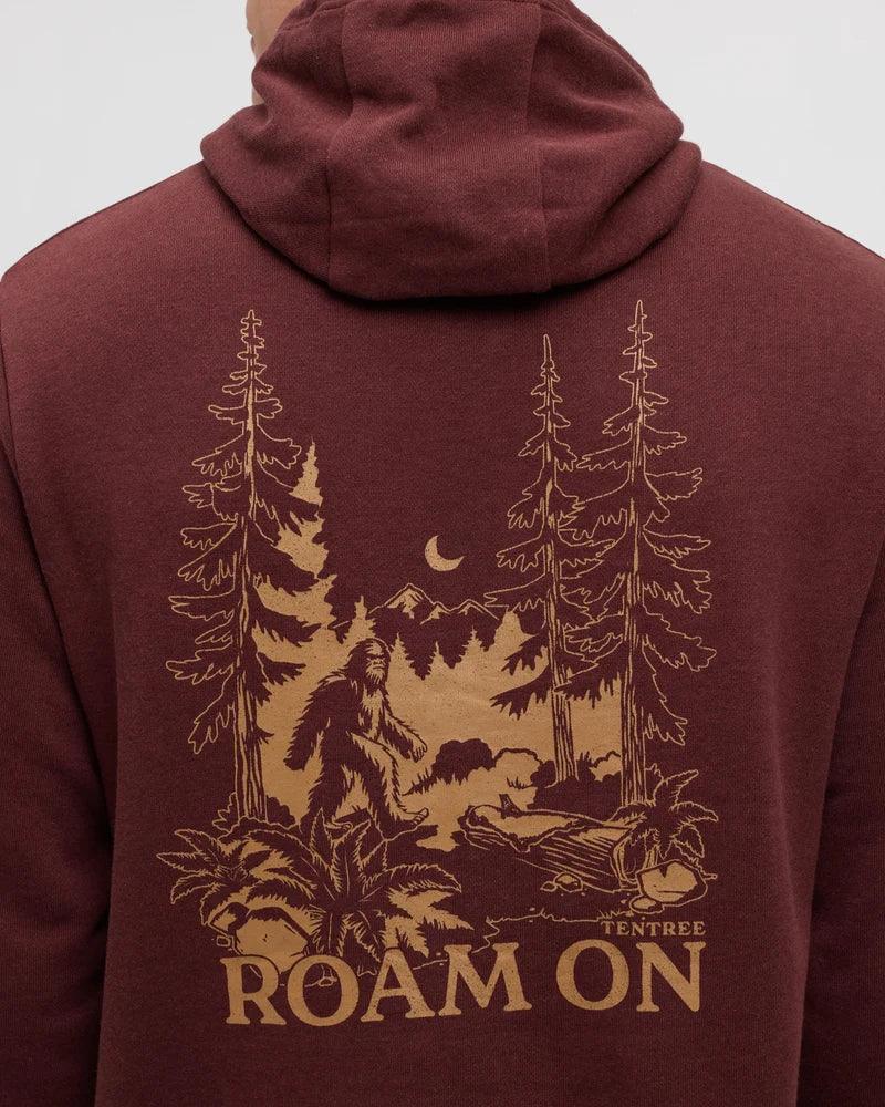 The back of a person wearing a hoodie with a picture of a sasquatch walking through the woods 
