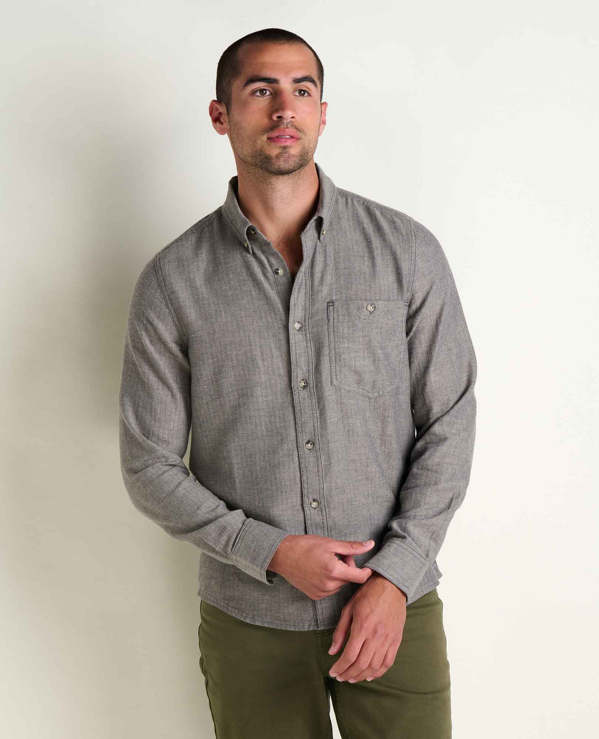 Toad & Co Airsmyth Long Sleeve Shirt a man standing with a grey button down shirt and green pants with a white background