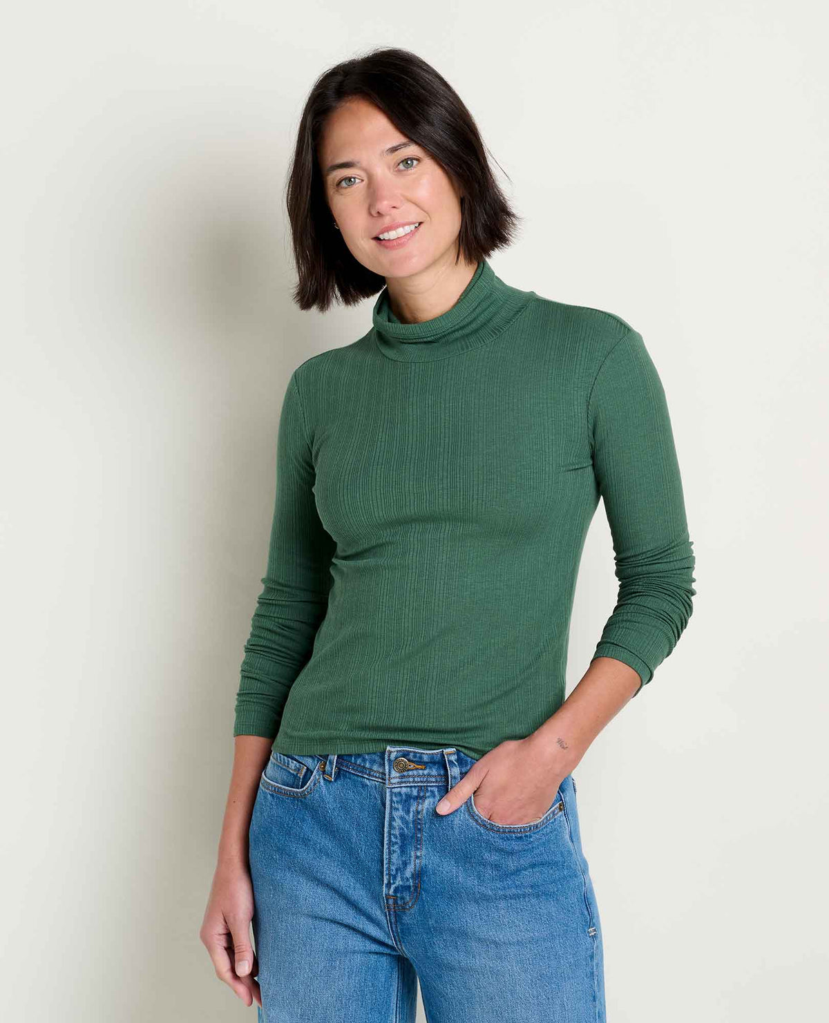 Toad & Co Rosalie Long Sleeve Turtle Neck woman wearing a green turtle neck and jeans 