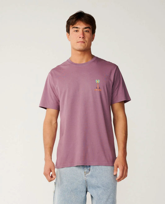 Man wearing a purple t-shirt with a small graphic on a plain background