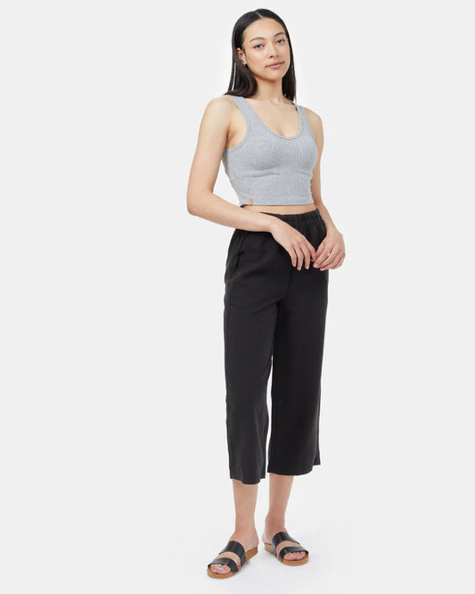 Tentree Billow Tree Linen pant A woman modeling a light gray ribbed crop tank top and black cropped pants with dark sandals, standing against a light gray studio background.
